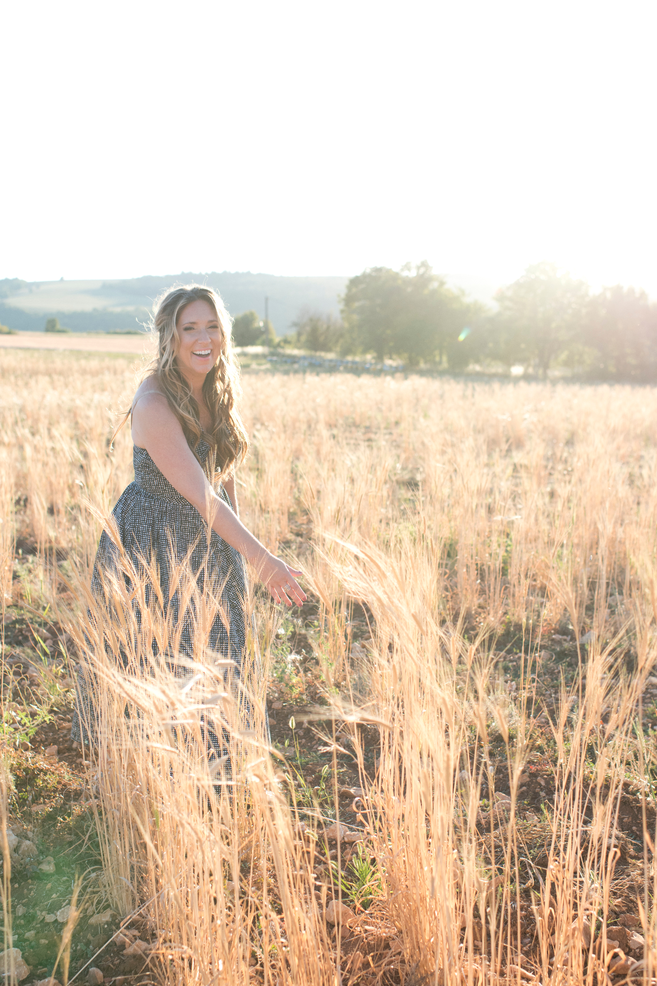 Gina DeVee at golden hour in a Provence wheat field
